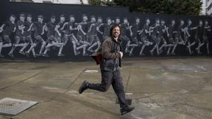 Teo Vázquez, muralista de gran formato, junto a su obra de 20 metros en el patio interior de la cooperativa de viviendas de Bac de Roda.