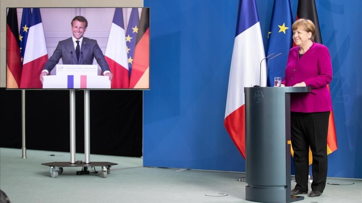 Un momento de la presentación del acuerdo, este lunes, entre Ángela Merkel y, en la pantalla, Enmanuel Macron. Un momento de la presentación del acuerdo, este lunes, entre Ángela Merkel y, en la pantalla, Enmanuel Macron.