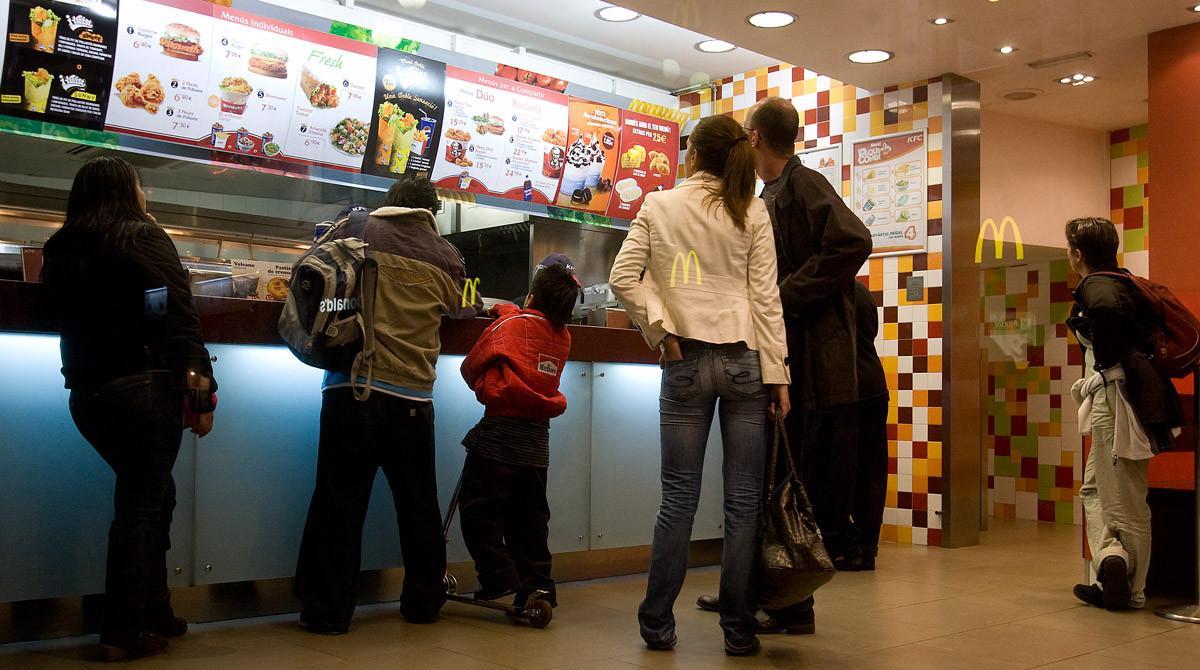 Local de comida rápida en Barcelona, en el que se ven reflejados los carteles de otro restaurante.