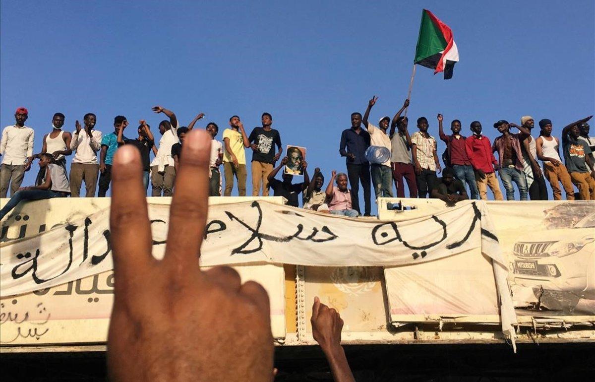 Manifestantes sudaneses piden la dimisión del presidente ante la sede del ministerio de Defensa en Jartum.