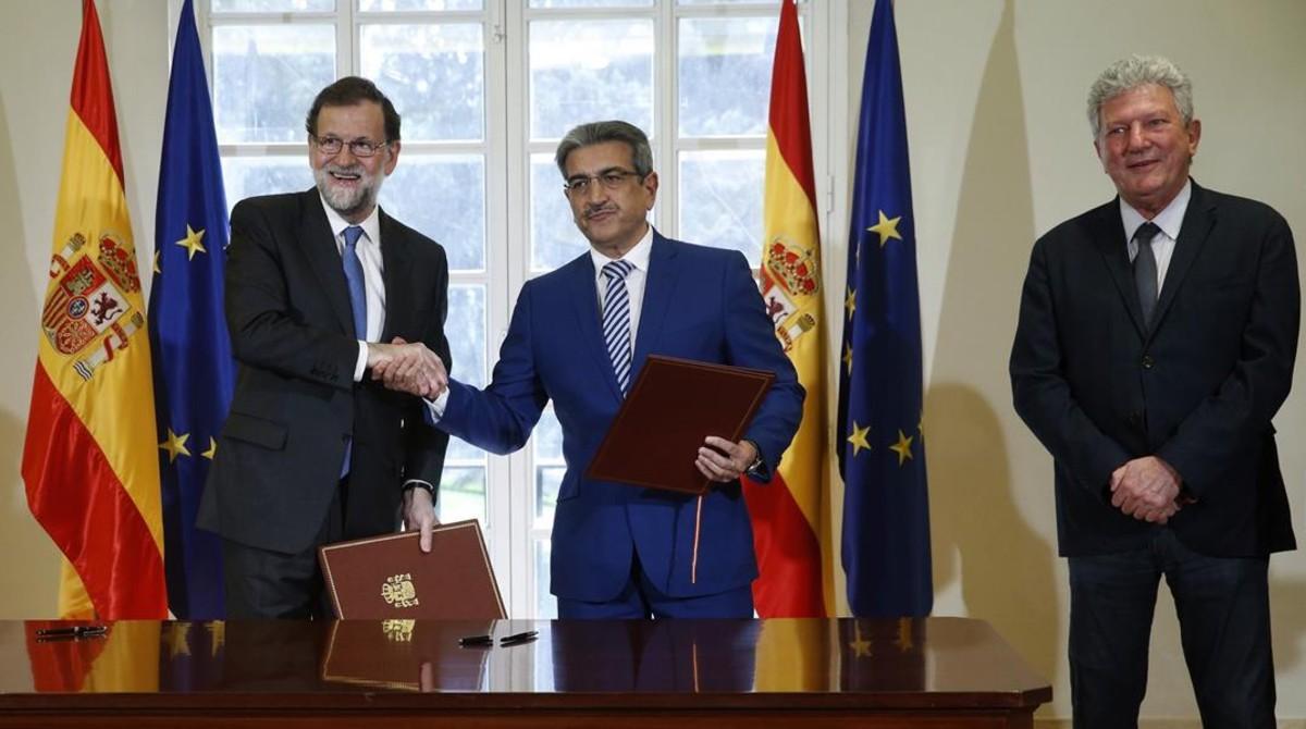 El presidente del Gobierno, Mariano Rajoy, el líder de Nueva Canarias, Román Rodríguez y el diputado Pedro Quevedo, durante la firma del acuerdo para aprobar los Presupuestos del 2017 en mayo.