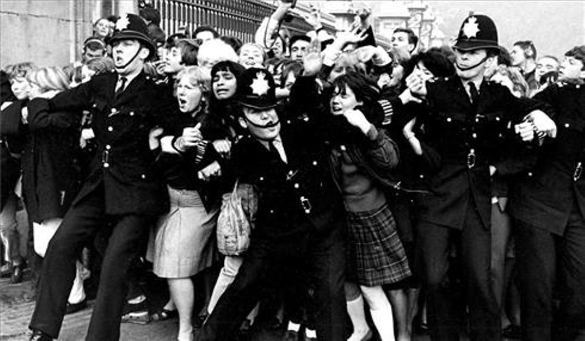 Los ’bobbies’ contienen la avalancha de fans de Beatles, en los 60. Los ’bobbies’ contienen la avalancha de fans de Beatles, en los 60.