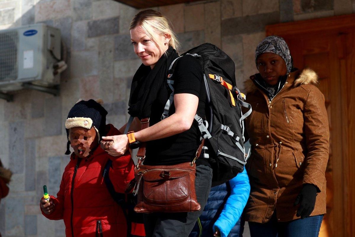 A member of an NGO accompanies two Caribbean children and their mother (R) as they prepare to leave the northeastern Syrian Kurdish-majority city of Qamishli - Syria’s Kurds handed two children from Trinidad and Tobago to their mother today, four years after their jihadist father brought them to the Islamic State group’s caliphate , a lawyer said. A member of an NGO accompanies two Caribbean children and their mother (R) as they prepare to leave the northeastern Syrian Kurdish-majority city of Qamishli - Syria’s Kurds handed two children from Trinidad and Tobago to their mother today, four years after their jihadist father brought them to the Islamic State group’s caliphate , a lawyer said.