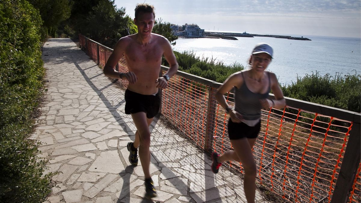 Una pareja de corredores en el Camino de Ronda desde Roc de Sant Gaieta Una pareja de corredores en el Camino de Ronda desde Roc de Sant Gaieta