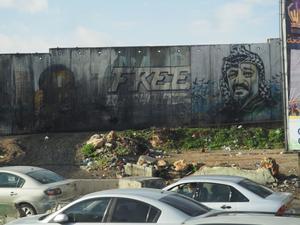 Un grafiti con el rostro del líder palestino Yasir Arafat en el muro de Cisjordania, junto al puesto de control de Qalandia, cerca de Ramala.