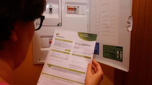 Factura de la luz. ¿En qué cambia con la nueva reforma?. En la foto, una mujer consulta una factura de la electricidad.