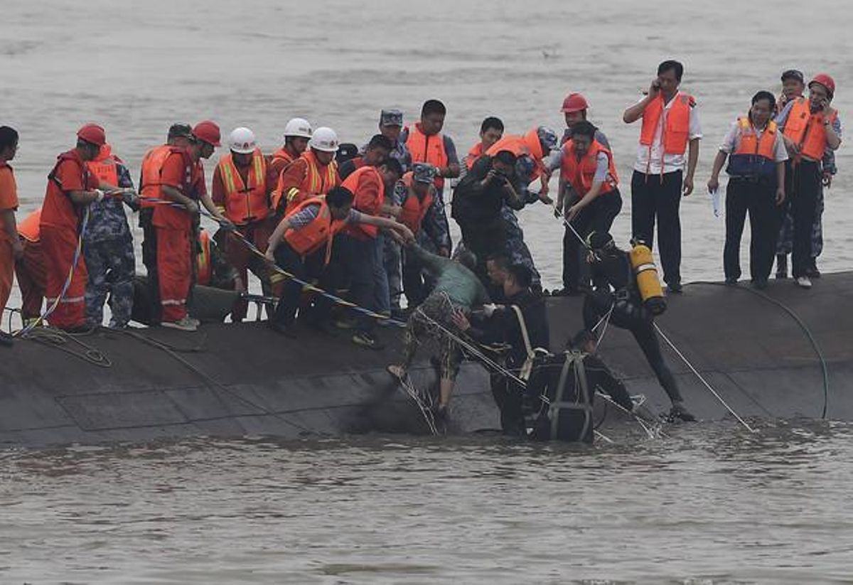 Los equipos de rescate sacan del agua a un superviviente del naufragio en el río Yangtsé. Los equipos de rescate sacan del agua a un superviviente del naufragio en el río Yangtsé.