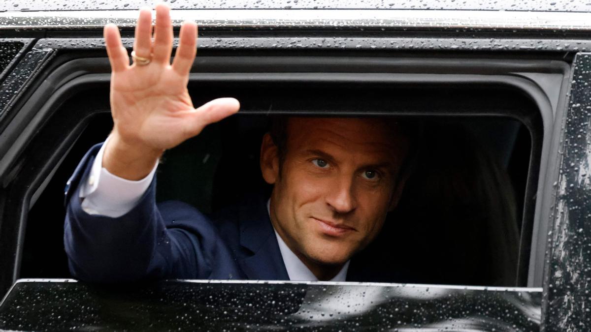 France’s President Emmanuel Macron waves as he leaves after casting his vote in the second stage of French parliamentary elections at a polling station in Le Touquet, northern France on June 19, 2022. (Photo by Ludovic MARIN / AFP)