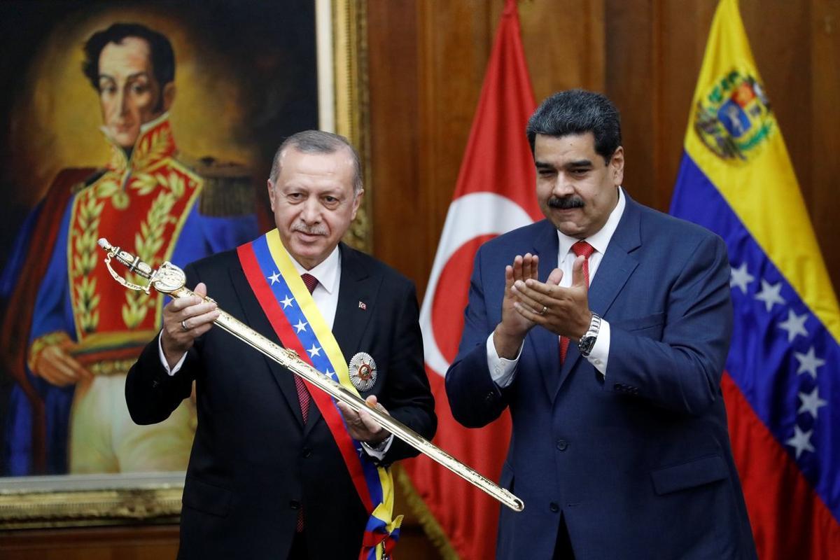 Turkish President Tayyip Erdogan holds a replica of the sword of national hero Simon Bolivar  next to Venezuela s President Nicolas Maduro  during an agreement-signing ceremony between Turkey and Venezuela at Miraflores Palace in Caracas  Venezuela. REUTERS Manaure Quintero