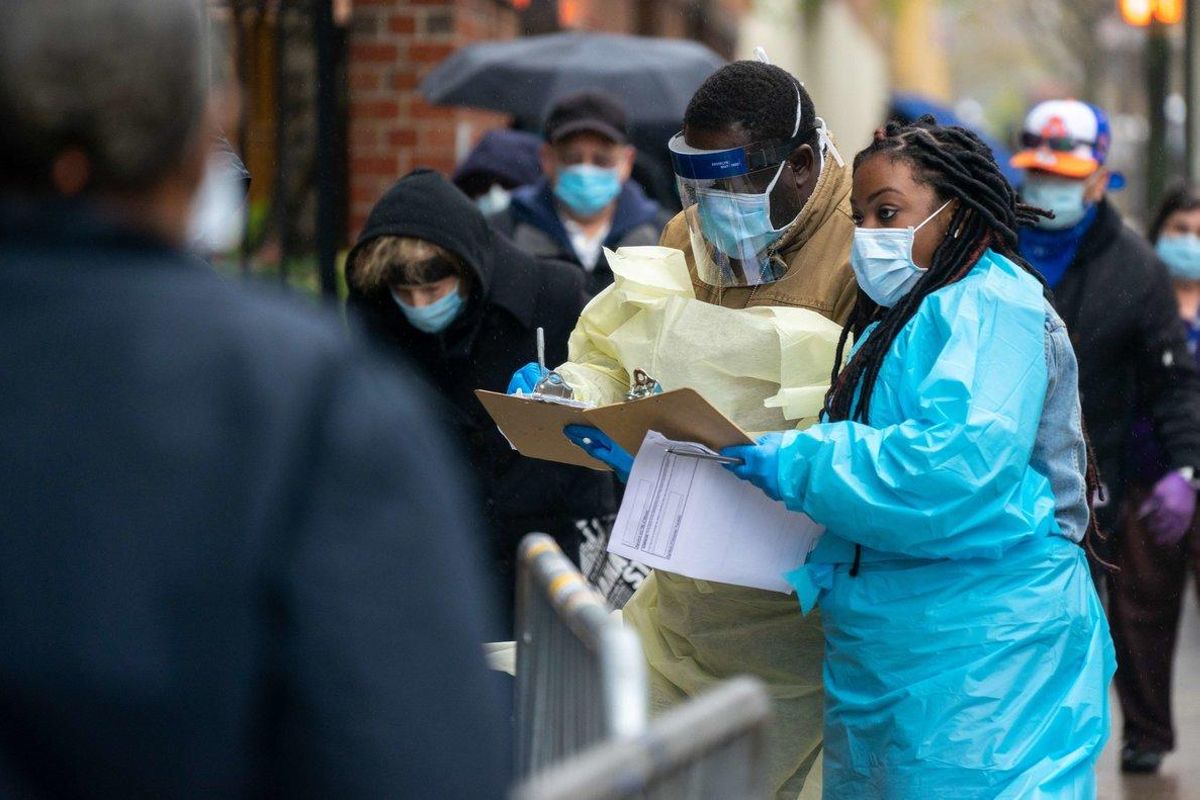 NEW YORK, NY - APRIL 24: Medical workers assist people standing in line at NYC Health + Hospitals/Gotham Health, Gouverneur waiting to be tested for the coronavirus (COVID-19) on April 24, 2020, in New York City. The NYC Health + Hospitals/Gotham Health, Gouverneur is one of the newest sites specifically for NYCHA city housing residents to open for diagnostic testing in some of the hardest-hit areas in New York City. David Dee Delgado/Getty Images/AFP NEW YORK, NY - APRIL 24: Medical workers assist people standing in line at NYC Health + Hospitals/Gotham Health, Gouverneur waiting to be tested for the coronavirus (COVID-19) on April 24, 2020, in New York City. The NYC Health + Hospitals/Gotham Health, Gouverneur is one of the newest sites specifically for NYCHA city housing residents to open for diagnostic testing in some of the hardest-hit areas in New York City. David Dee Delgado/Getty Images/AFP