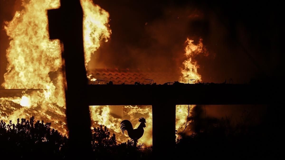El fuego arrasa un jardín de una casa en Mati, un suburbio al noreste de Atenas. El fuego arrasa un jardín de una casa en Mati, un suburbio al noreste de Atenas.