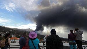 El volcán de La Palma cumple dos meses en erupción. En la foto, un grupo de gente observa la actividad del volcán en la plaza de Tajuya, en el municipio de El Paso. 