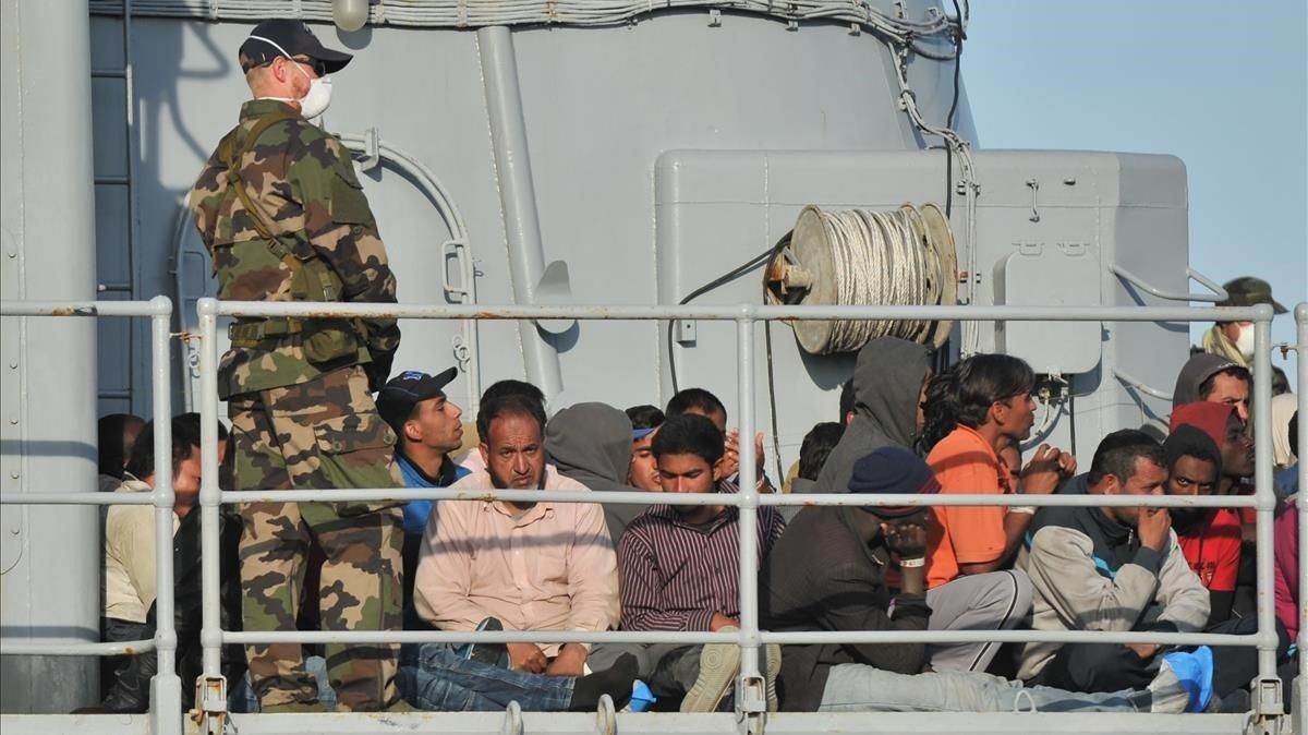 Inmigrantes rescatados por un barco militar francés en el puerto de Crotone, en el sur de Italia. Inmigrantes rescatados por un barco militar francés en el puerto de Crotone, en el sur de Italia.