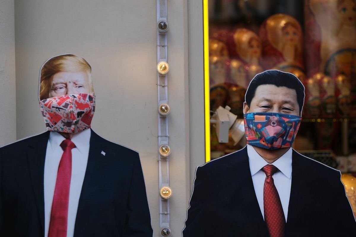A view shows cardboard cutouts, displaying images of U.S. President Donald Trump and Chinese President Xi Jinping, with protective masks widely used as a preventive measure against coronavirus disease (COVID-19), near a gift shop in Moscow, Russia March 23, 2020. REUTERS/Evgenia Novozhenina A view shows cardboard cutouts, displaying images of U.S. President Donald Trump and Chinese President Xi Jinping, with protective masks widely used as a preventive measure against coronavirus disease (COVID-19), near a gift shop in Moscow, Russia March 23, 2020. REUTERS/Evgenia Novozhenina