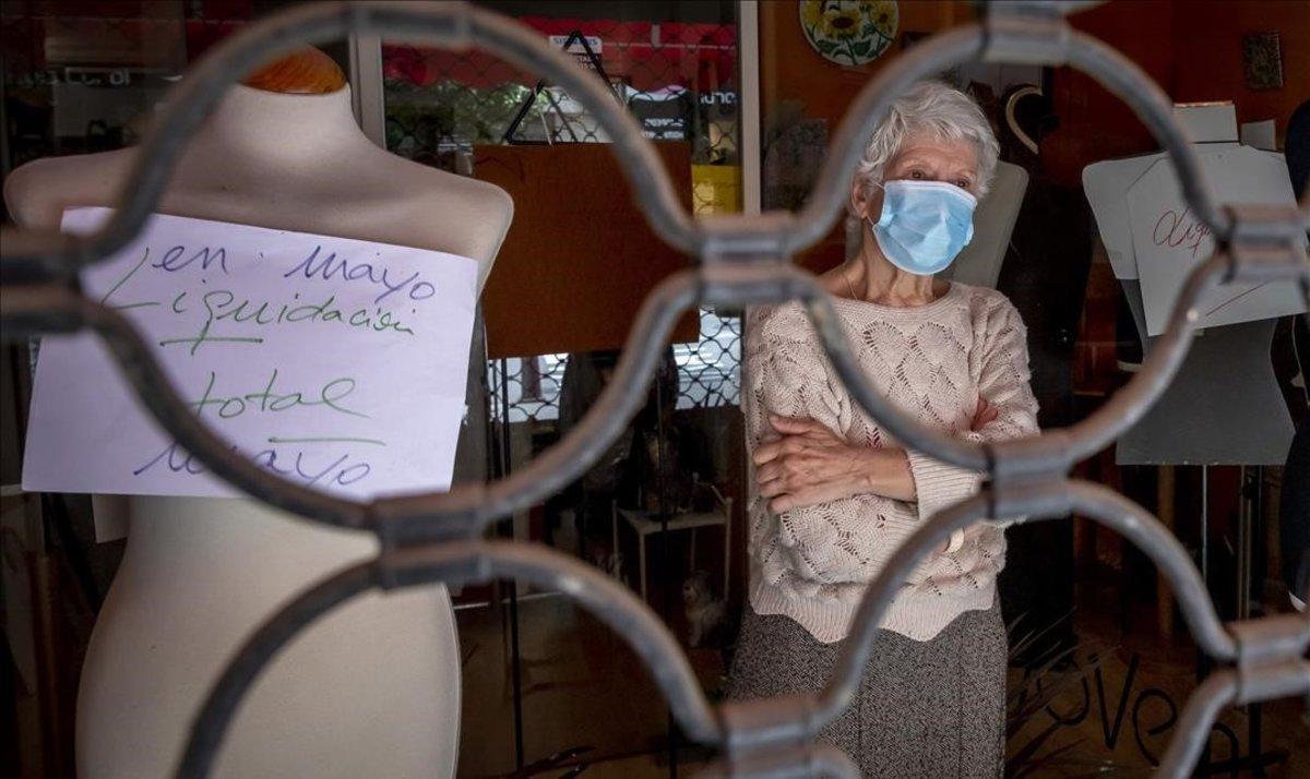 Berta Lema, entre los maniquís ya desnudos de una tienda de ropa que echará el cierre, en València.