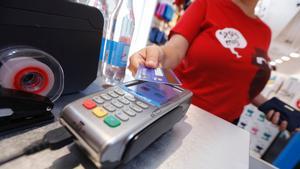 Una mujer paga con una tarjeta de crédito en un establecimiento de Barcelona.