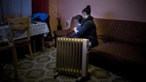 Una mujer, con uno de sus hijos, víctimas de la pobreza energética, en su piso de Barcelona.
