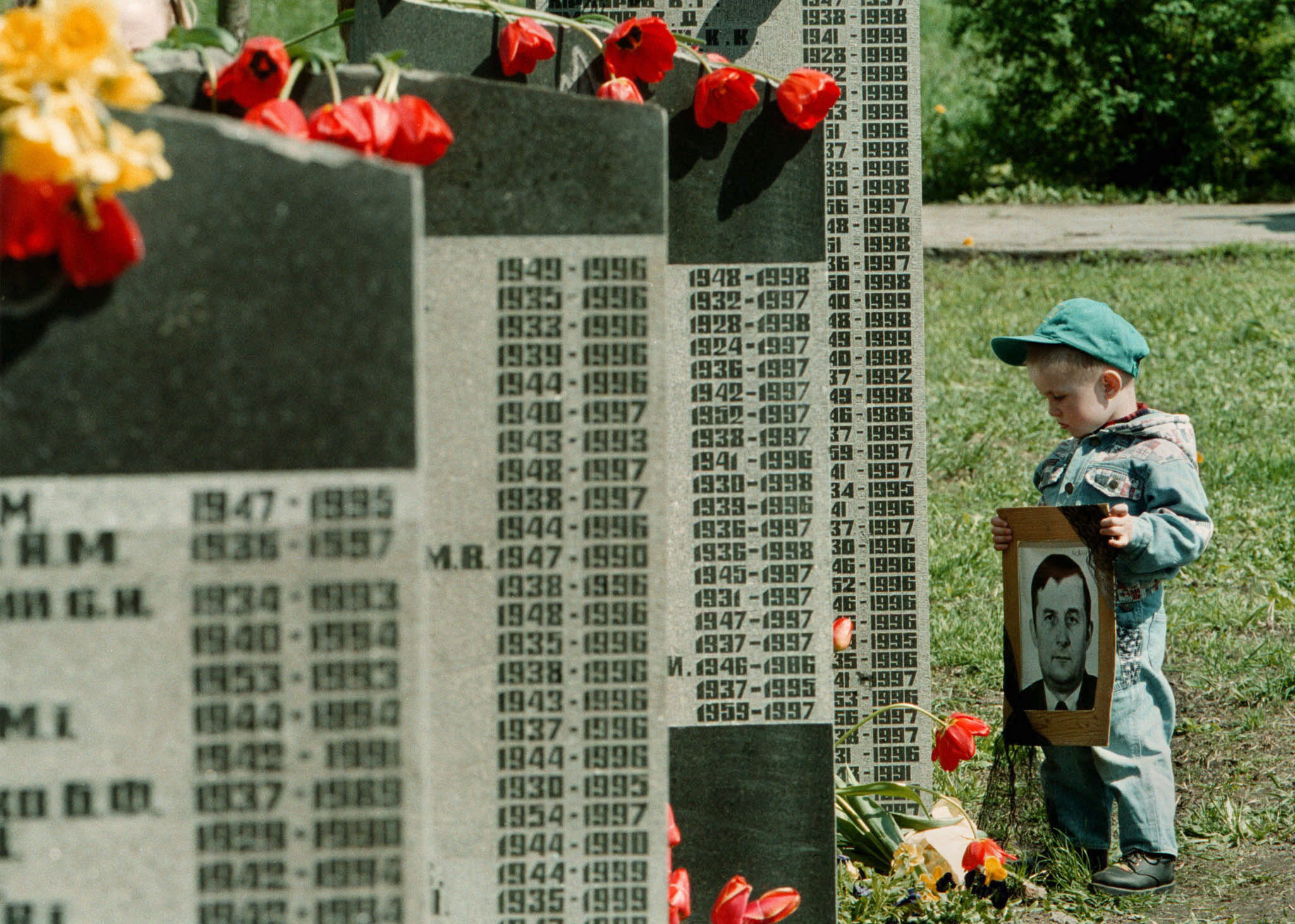 Un niño ucraniano sostiene una foto de su difunto abuelo, fallecido por las consecuencias de la catástrofe nuclear de Chernóbil, en Kiev. | EPA